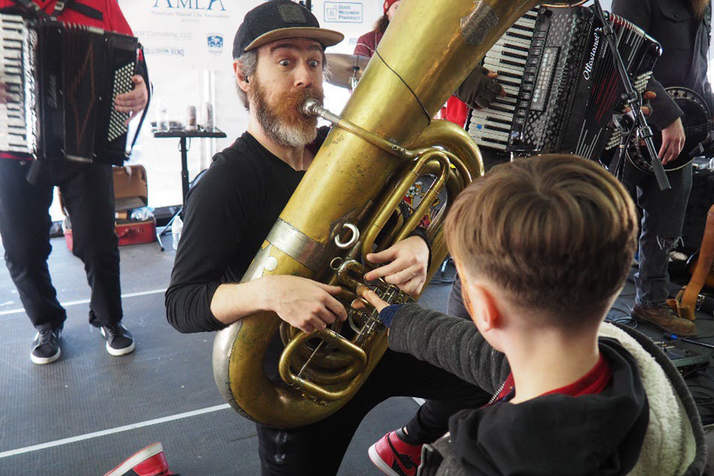 Tuba player from the Chardon Polka Band entertaining a young festival goer